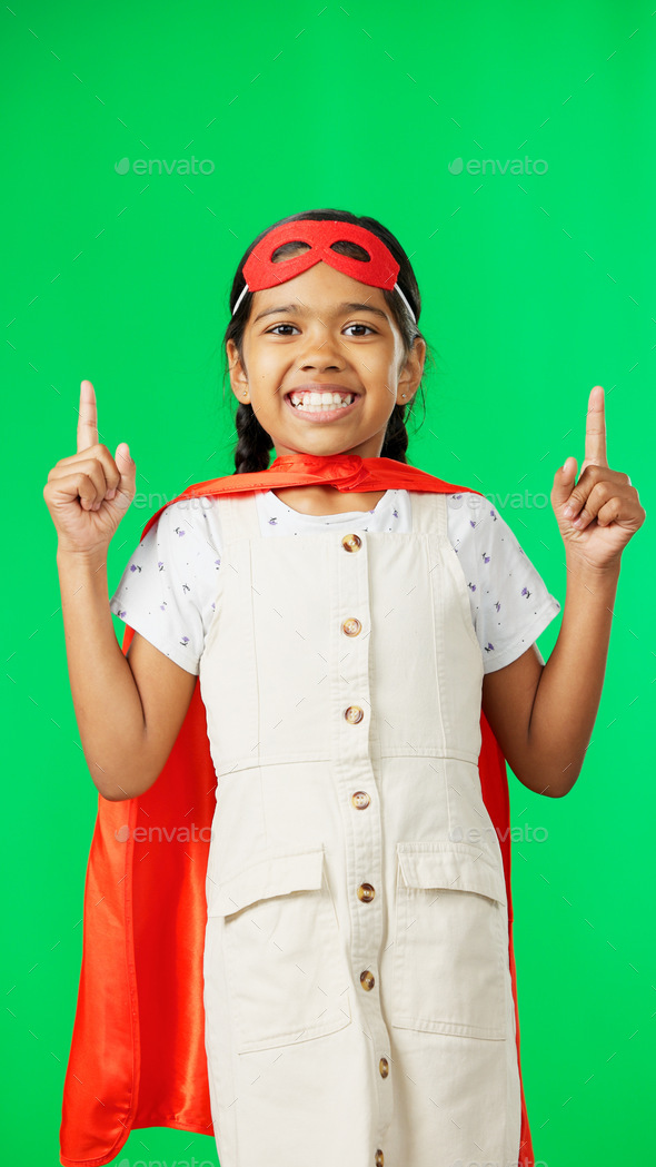 Superhero, point and face of child on green screen for fantasy, cosplay costume and comic character