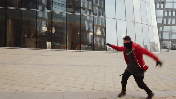 Athlete Performing Parkour Side Flip Outdoors in City Downtown alt