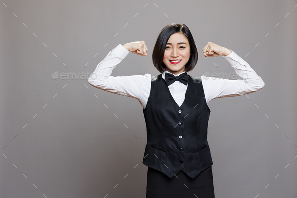 Receptionist showcasing bicep muscles Stock Photo by DC_Studio