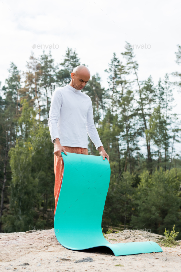 full length view of buddhist in sweatshirt and harem pants