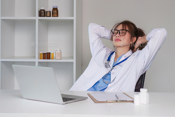Stressed young female doctor looking at laptop, work related chaos, worried about mistake at work