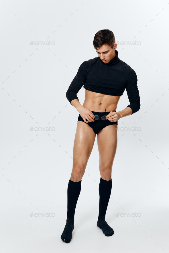 guy model in golf shorts and a sweater on a light background inflated torso er