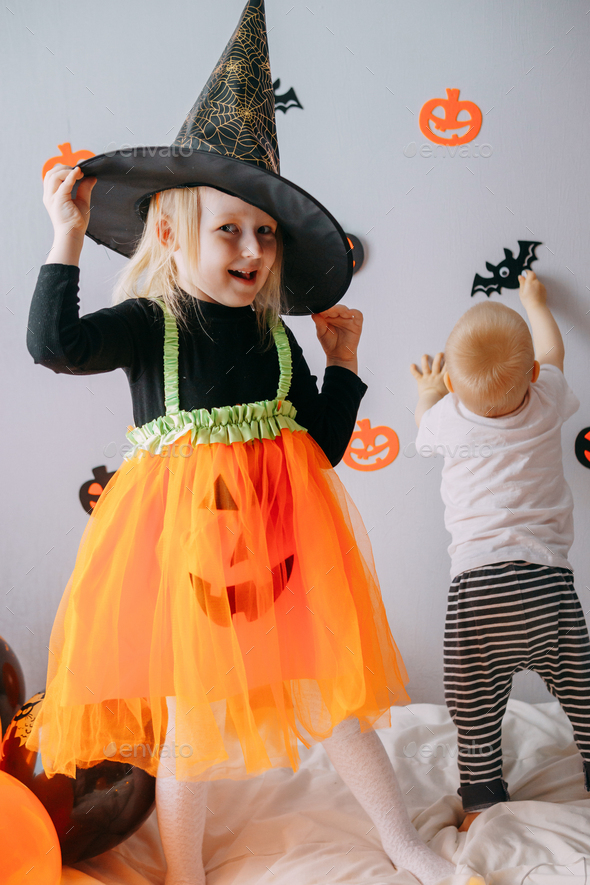 Children's Halloween - a boy and a girl in carnival costumes with ...