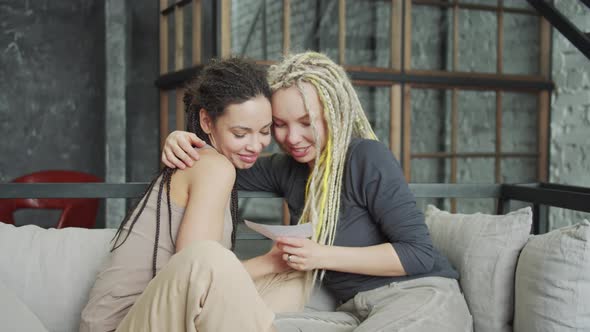 LGBT Couple Holding Ultrasound Photo of the Future Baby