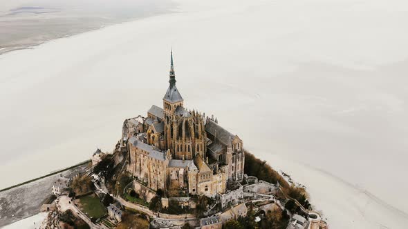 Drone Zooming Out, Flying Up and Away From Mont Saint Michel Epic Island Abbey Landmark During Low alt