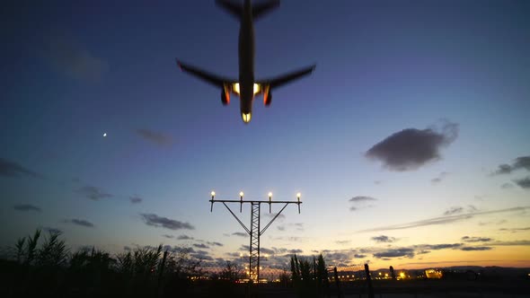 Airplane Landing at Airport Sunset