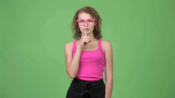 Young Happy Beautiful Nerd Woman with Finger on Lips alt