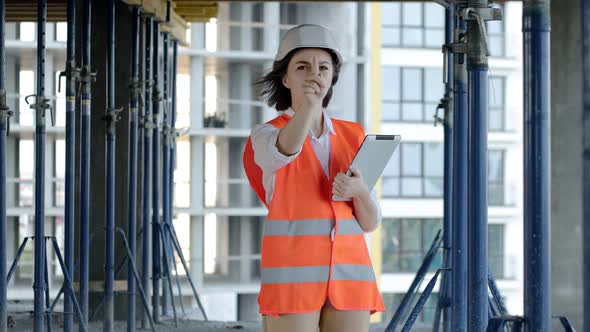 Female construction engineer. Architect with a tablet computer at a construction site alt