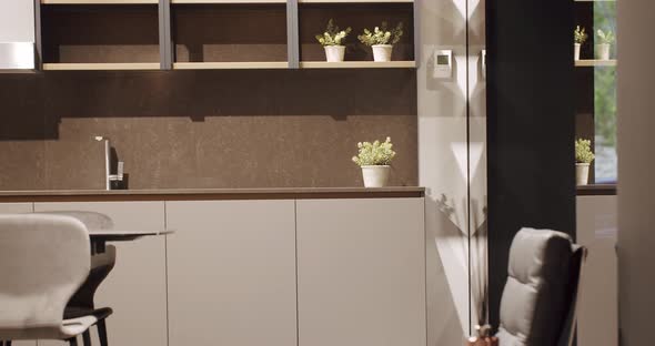 Modern gray and white kitchen furniture with marble table. Comfortable Home alt