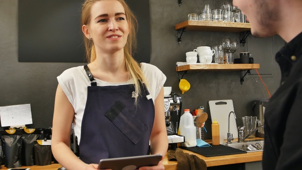 Portrait of a gorgeous female barista taking the order