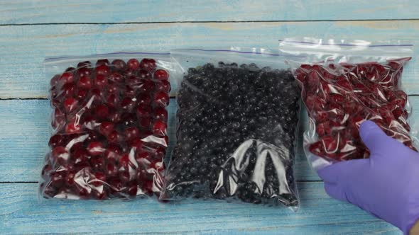 Packages with Blueberry, Cherry, Raspberry in Zipper Plastic Bags for Freezing. Frozen Berries Food alt