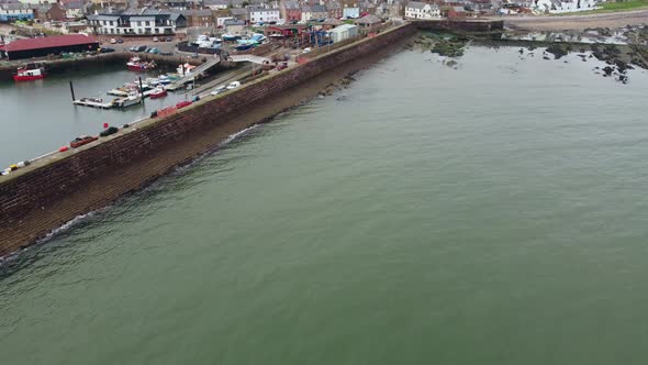 Drone View of the Sea Coast Near the Pier with the Town in the Background