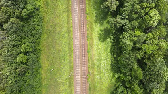 Train Way, Railroad tracks Through Green Grassed Countryside, Aerial, Drone View. alt