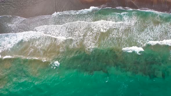 Aerial View of the Mediterranean Coast Waves Reach the Deserted Sandy Beach alt