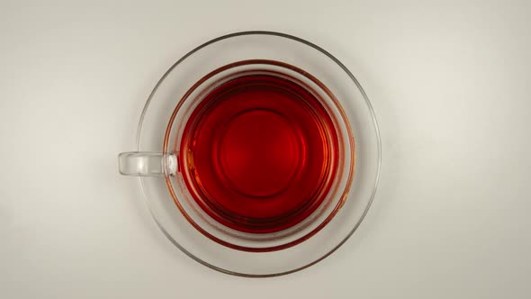 Drinking a black tea from a glass tea cup