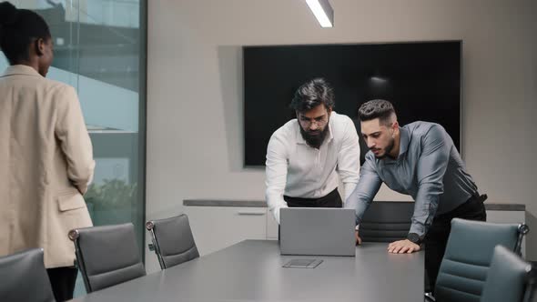 Two Arabian Male Partner Colleagues Looking at Laptop Working Discussing Online Data African alt