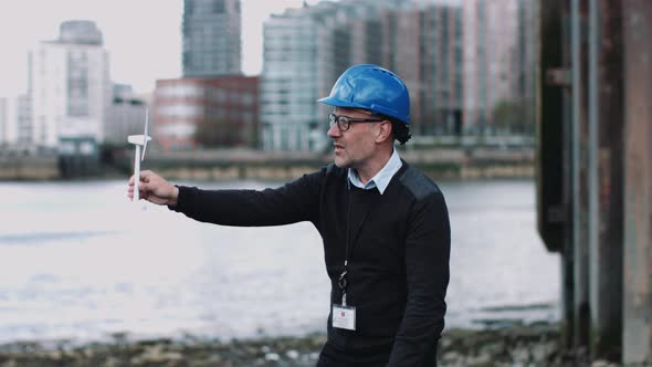 Engineer working on a Wind Turbine project at river bank