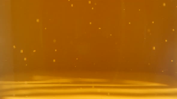 View on  golden  beer in the glass spreading bubbles 4K 2160p 30fps UltraHD footage - Light beer foa