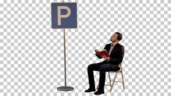 Young man reading a book near parking sign, Alpha Channel
