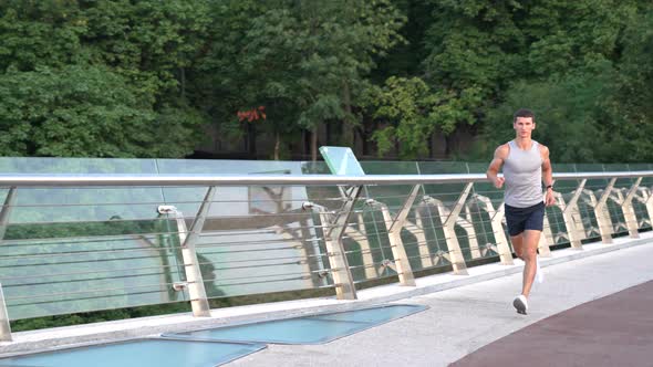 Muscular Young Man Runner in Sportswear Running and Training Stamina Sprint alt