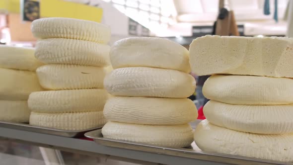 Closeup of Piles of Round Homemade Traditional Cheese in the Market in Georgia alt