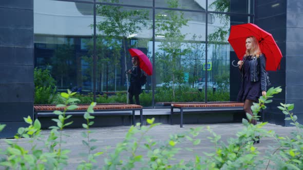 Girl with Red Umbrella Goes Along Urban Street alt