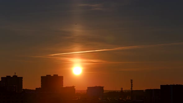 Sunrise at cold winter morning with sun pillar in the sky, orange sunrise in the city, Vilnius