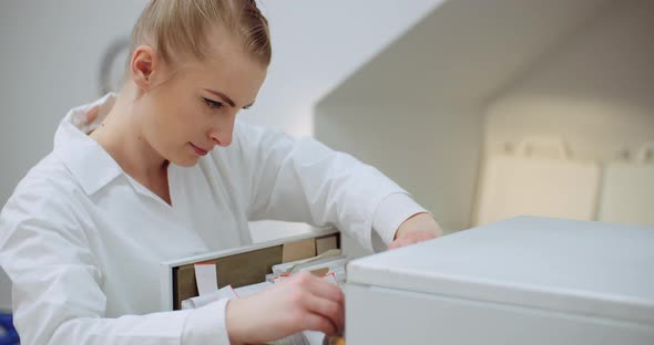 Female Doctor Looks for Personal Data in the File alt