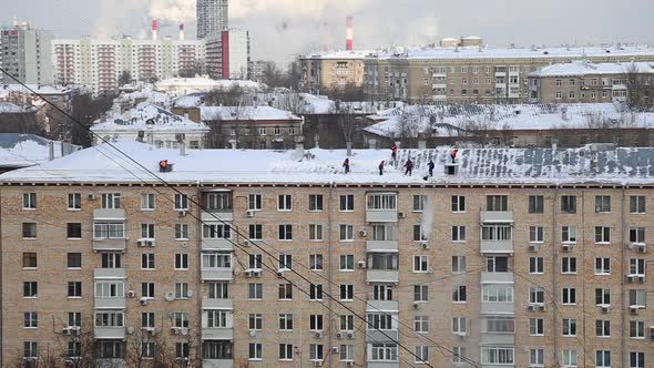 Cleaning the roof from snow in a residential area of Moscow, Russia