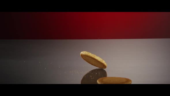 Falling cookies from above onto a reflective surface - COOKIES  alt