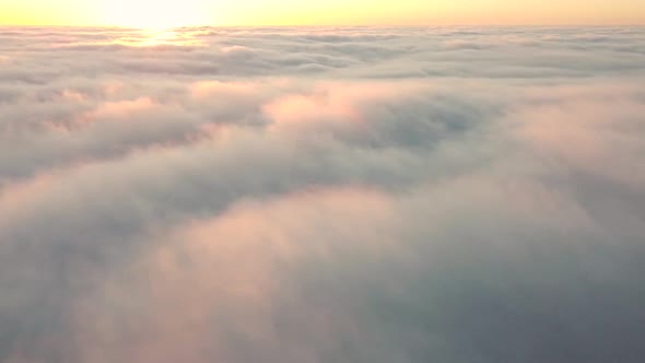 Morning fog and sun on the horizon, time-lapse wind drives clouds high in the sky alt