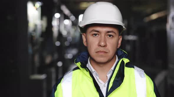 Closeup Portrait of Confident Handsome Male Foreman in Hardhat Looking to Camera