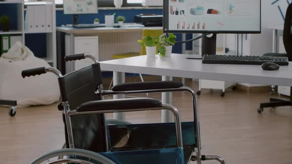 Wheelchair for Handicapped Employees Placed Inmodern Empty Workspace alt