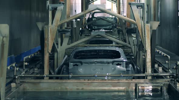 Factory Unit with Zinc and an Automobile Carcass Getting Put Into It alt