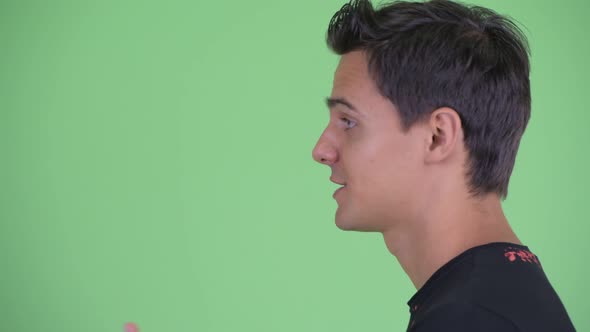 Closeup Profile View of Happy Young Handsome Man Talking alt