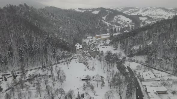 4k Drone Shot Draculas Castle In Winter With Cars Passing By