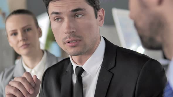 Businessman Talking at Meeting alt