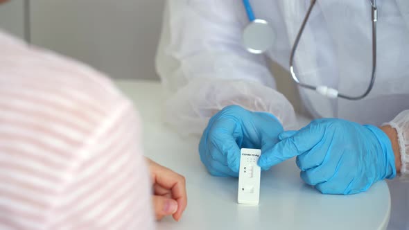 Doctors Give Rapid Antigen Test for Covid19 to Female Patient in Clinic alt