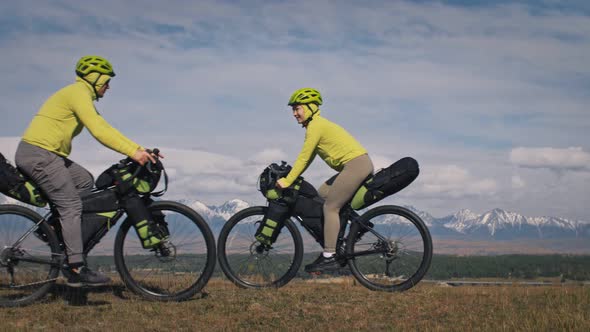 The Man and Woman Travel on Mixed Terrain Cycle Touring with Bikepacking alt