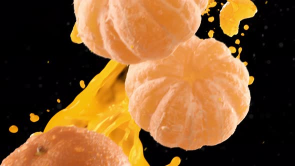 Tangerine with Slices Falling on Black Background alt