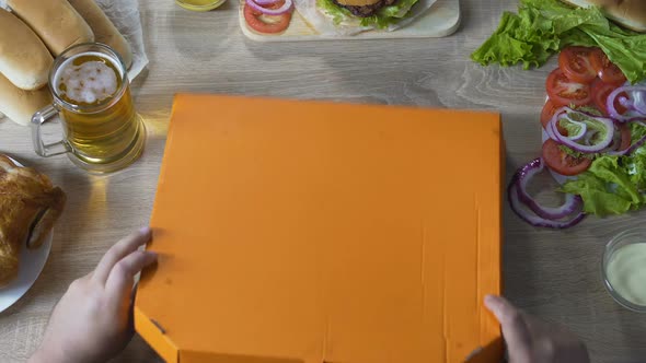 Hungry man opening box of pizza and finding it empty, moment to go on diet alt