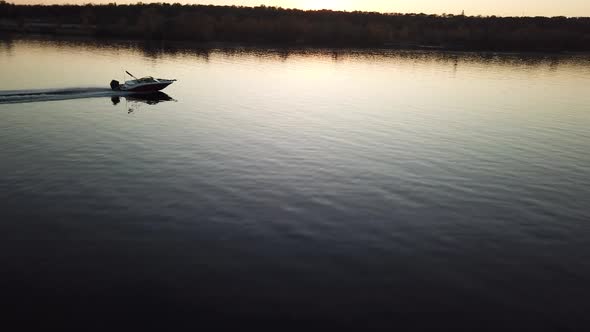  Motor Boat Floating on the River at Sunset