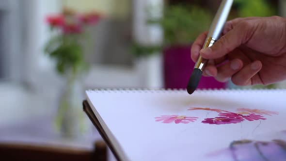 Artist's Hand Painting Flowers