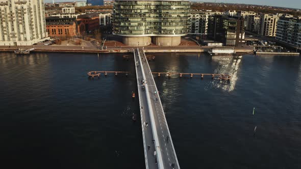 People By the Biker's Bridge with Both Old and Modern Buildings Surrounding It
