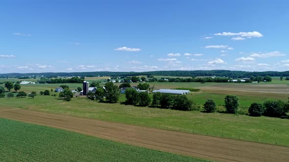Aerial View of the Farm Countryside With Planted Fields and a Single Rail Road Track alt