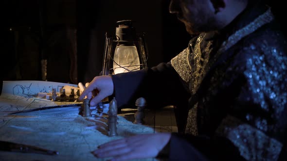 Working on a map with a sword in the historical period. alt