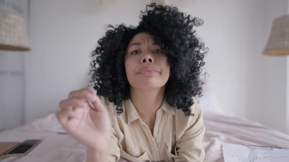 Web Camera POV of Confident Woman Adjusting Video Chat Lying in Cozy Bed in Home Office alt