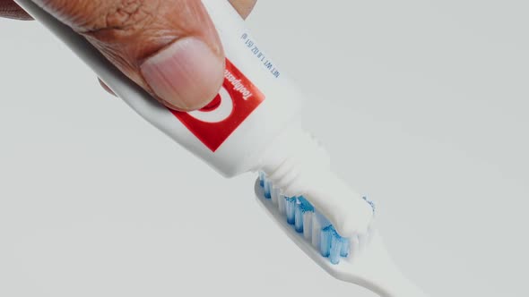 Sqeezing Toothpaste Onto Tooth Brush