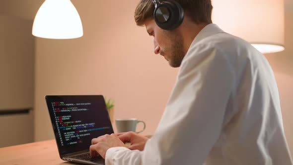 Male Programmer is Working on Creating Software Typing Program Code on a Laptop Keyboard Programmer alt