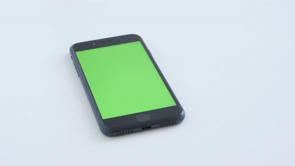 ZAJECAR, SERBIA - NOVEMBER 2016 Slow tilt  on chroma key modern phone with green screen on white bac